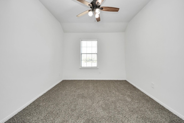 empty room with ceiling fan, carpet floors, and vaulted ceiling