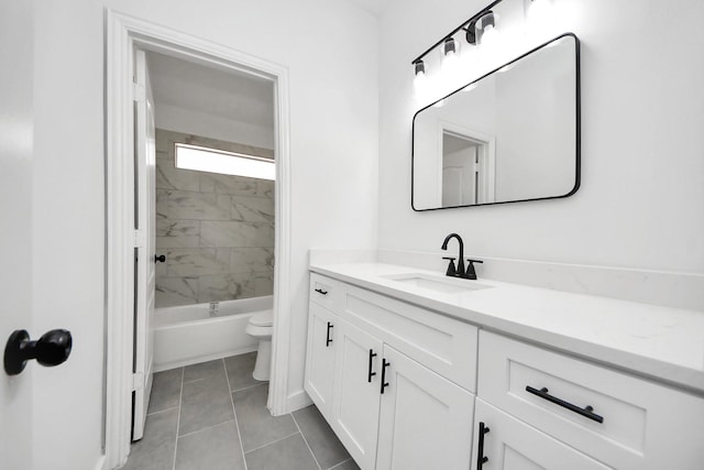 full bathroom with tile patterned flooring, vanity, toilet, and tiled shower / bath