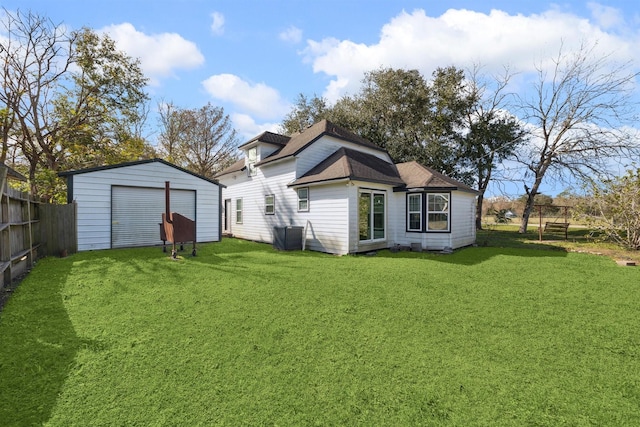 rear view of house with a lawn and an outbuilding