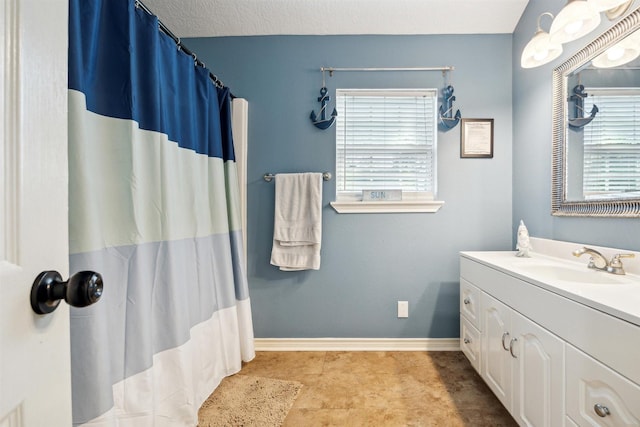 bathroom with vanity and a textured ceiling