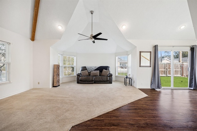 living room with lofted ceiling with beams, ceiling fan, and a wealth of natural light