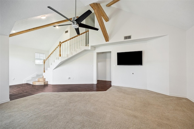 unfurnished living room featuring ceiling fan, beamed ceiling, high vaulted ceiling, a textured ceiling, and dark carpet