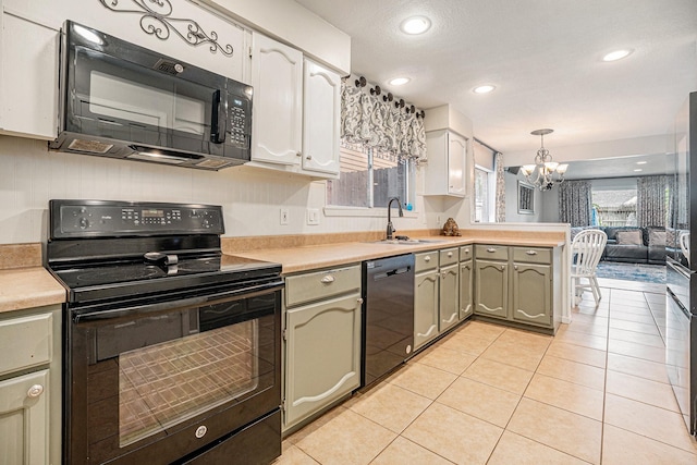 kitchen with black appliances, hanging light fixtures, light tile patterned floors, a notable chandelier, and sink