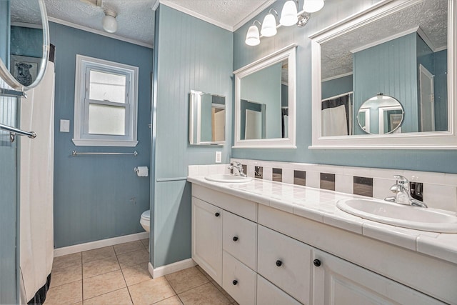 bathroom with toilet, a textured ceiling, tile patterned floors, ornamental molding, and vanity