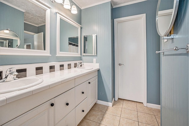 bathroom with ornamental molding, tile patterned flooring, a textured ceiling, and vanity