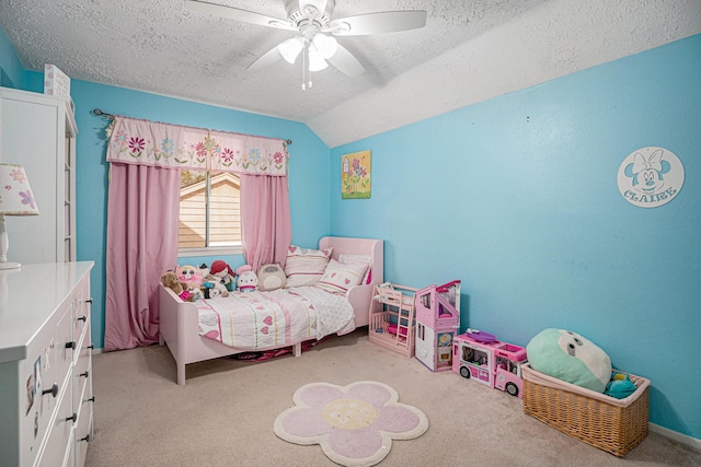 bedroom with lofted ceiling, a textured ceiling, ceiling fan, and light carpet