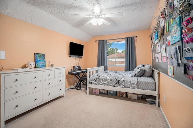 bedroom with a textured ceiling, ceiling fan, light carpet, and lofted ceiling