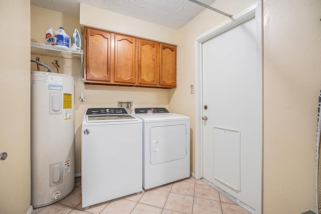 laundry room with a textured ceiling, cabinets, electric water heater, separate washer and dryer, and light tile patterned flooring