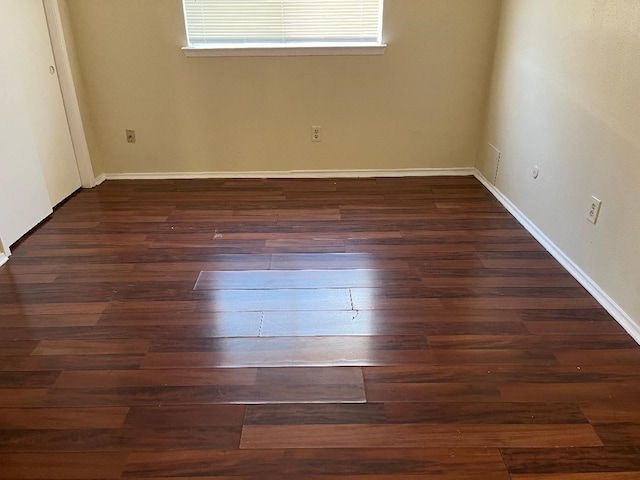 unfurnished bedroom with dark wood-type flooring