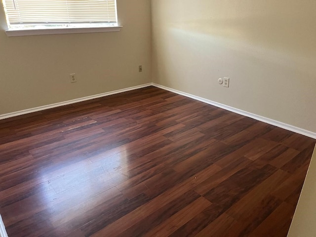 spare room featuring dark hardwood / wood-style flooring