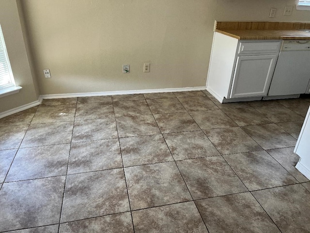 unfurnished dining area featuring tile patterned floors