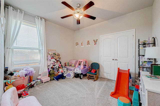 game room with carpet flooring and ceiling fan