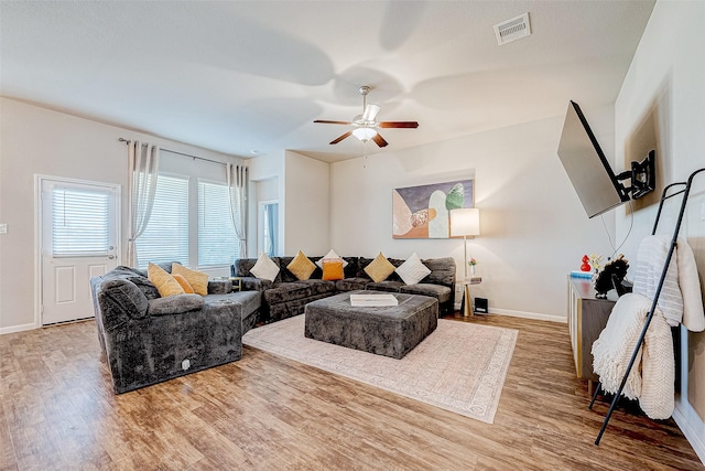 living room with hardwood / wood-style floors and ceiling fan