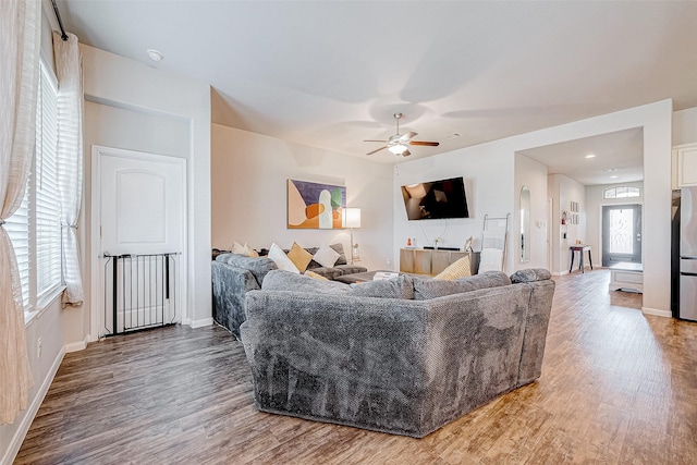 living room with hardwood / wood-style flooring and ceiling fan