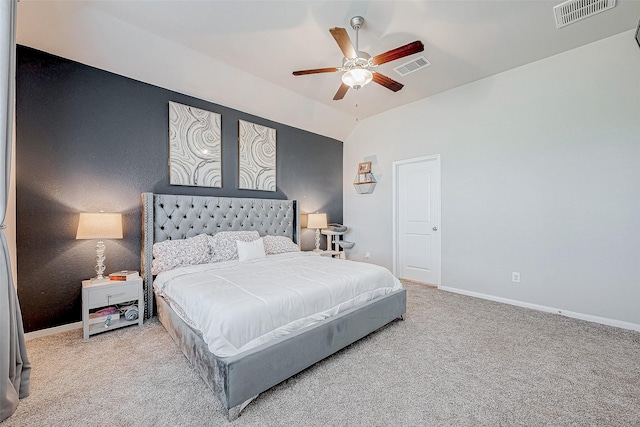 carpeted bedroom with ceiling fan and vaulted ceiling