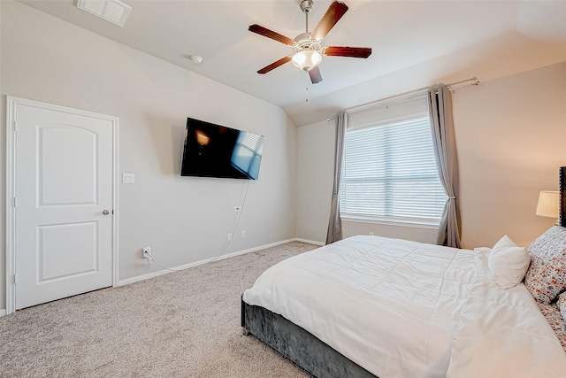 carpeted bedroom with ceiling fan and vaulted ceiling