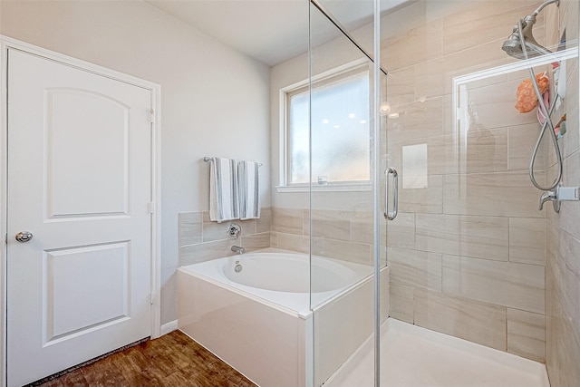 bathroom featuring plus walk in shower and wood-type flooring