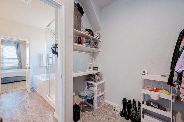 walk in closet featuring light hardwood / wood-style flooring