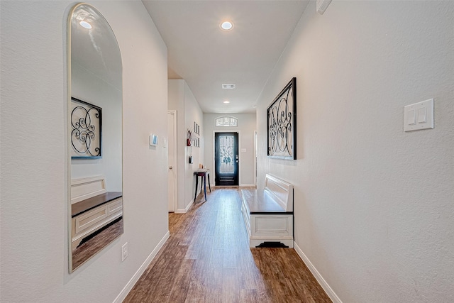 hallway with hardwood / wood-style flooring