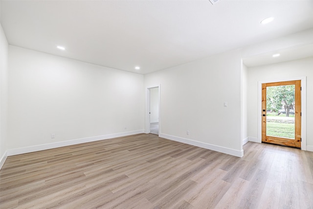 spare room with light hardwood / wood-style flooring