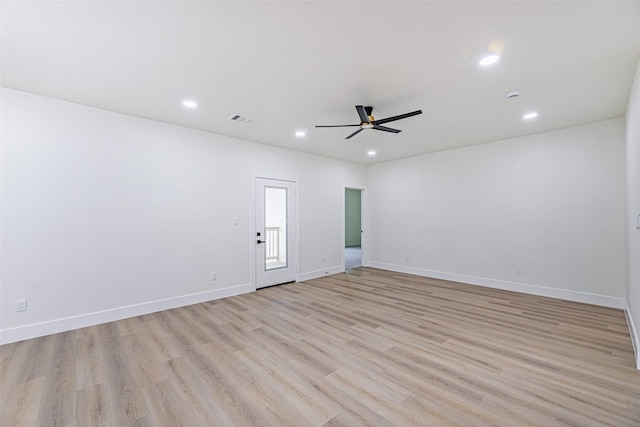 spare room with light wood-type flooring and ceiling fan