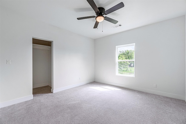 unfurnished room with ceiling fan and light colored carpet