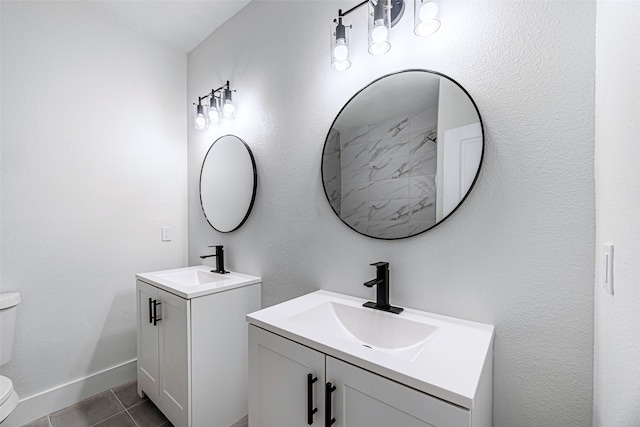 bathroom featuring tile patterned flooring, vanity, and toilet