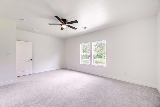 carpeted spare room with ceiling fan