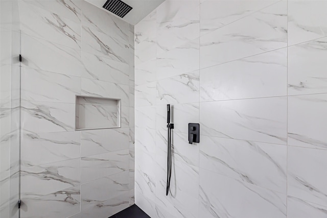 bathroom with a tile shower