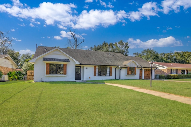 ranch-style house featuring a front lawn and a garage