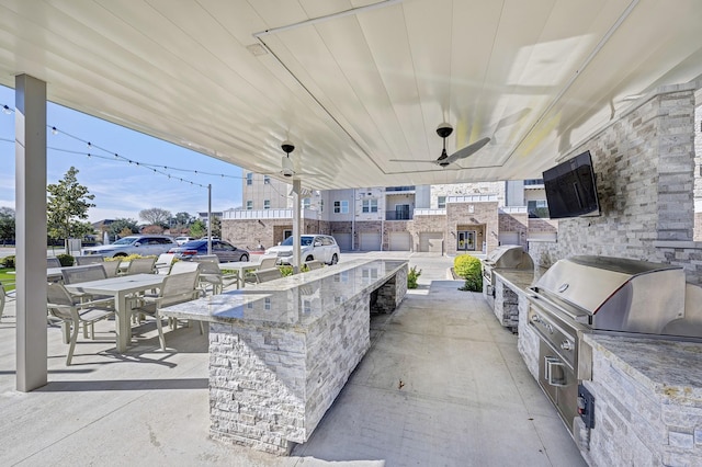 view of patio with area for grilling and ceiling fan