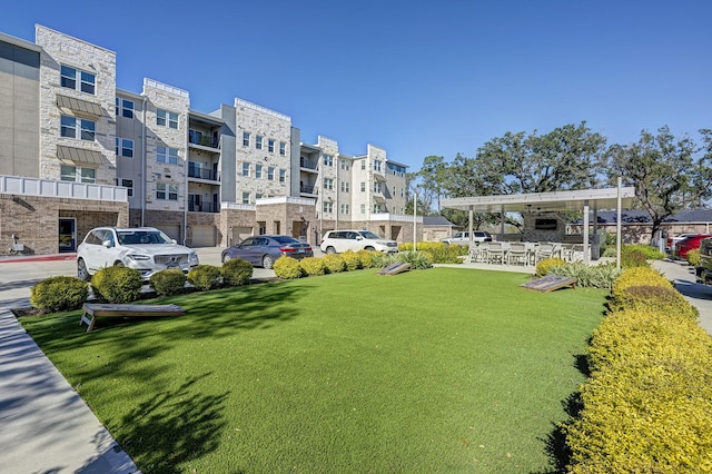 view of property's community with a yard