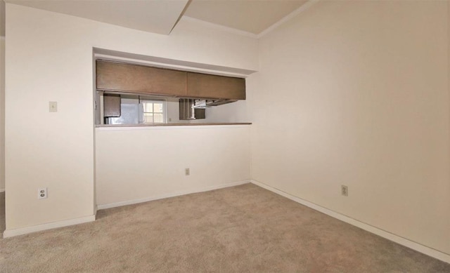 carpeted spare room with ornamental molding