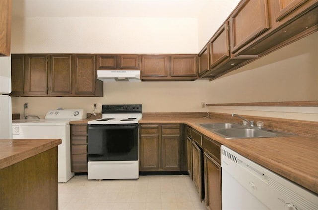 kitchen featuring white appliances, washer / clothes dryer, and sink