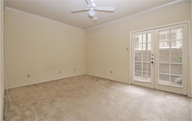 carpeted empty room with ceiling fan, crown molding, and french doors