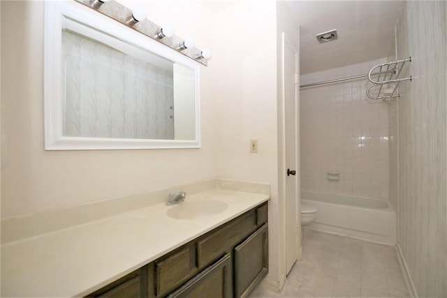 full bathroom with tile patterned flooring, vanity, toilet, and tiled shower / bath combo