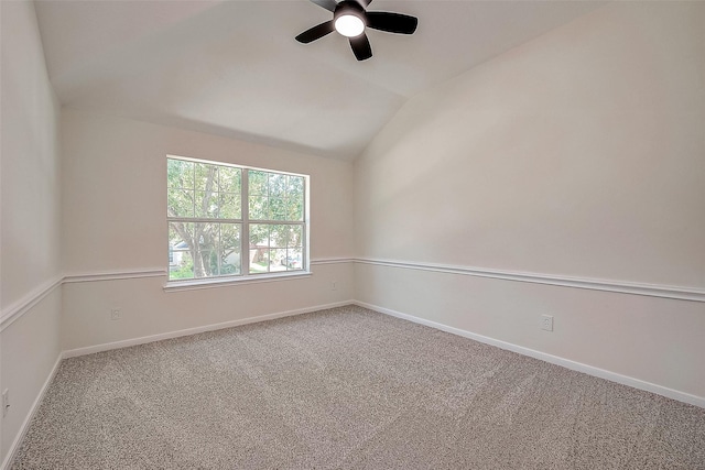 carpeted empty room featuring ceiling fan and vaulted ceiling