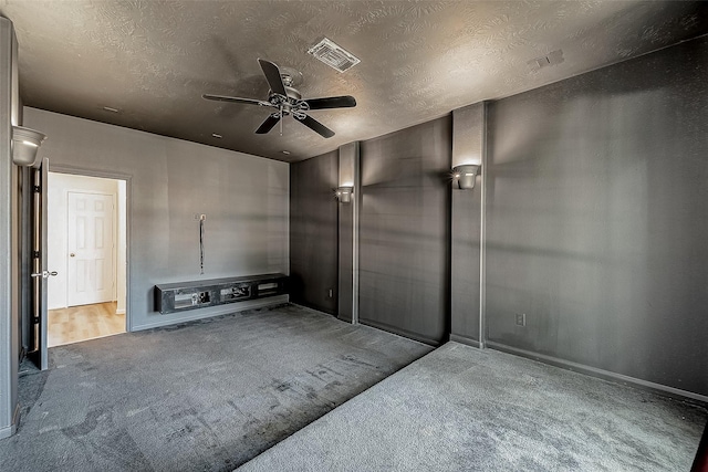 interior space featuring ceiling fan and a textured ceiling