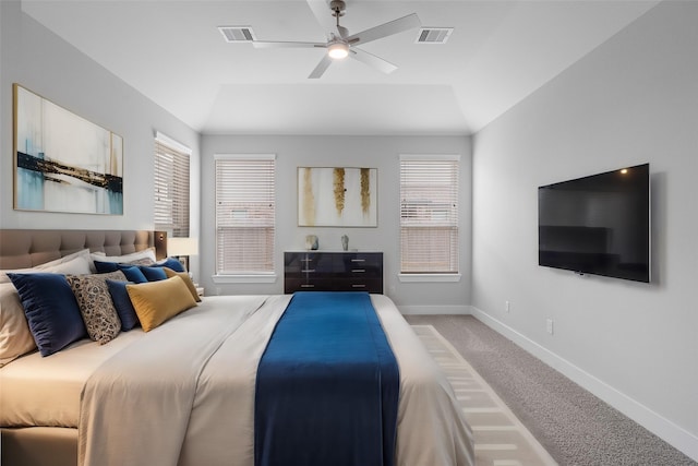 carpeted bedroom featuring multiple windows, ceiling fan, and vaulted ceiling