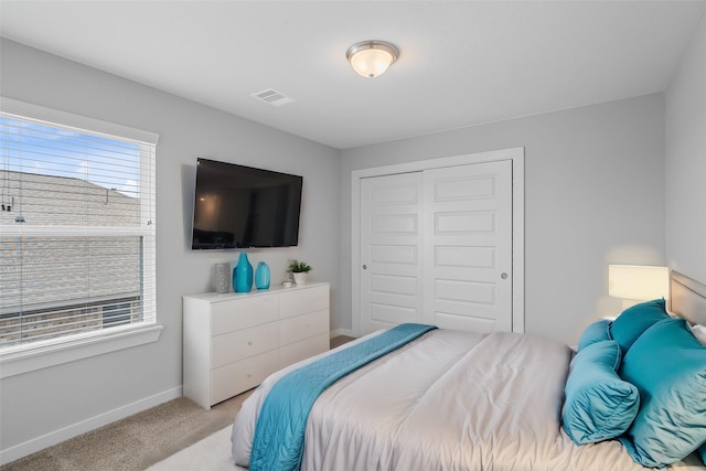 carpeted bedroom with a closet