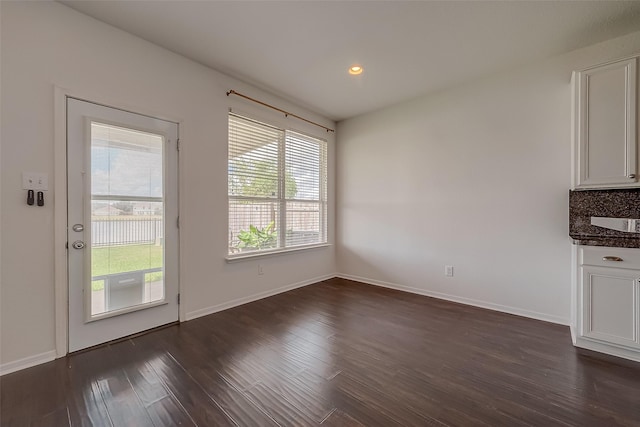 unfurnished dining area with dark hardwood / wood-style flooring