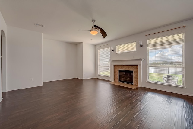 unfurnished living room featuring dark hardwood / wood-style floors, ceiling fan, and a premium fireplace