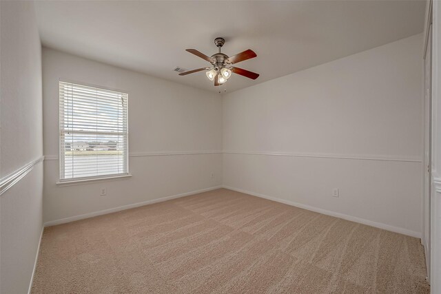 unfurnished room with ceiling fan and light carpet