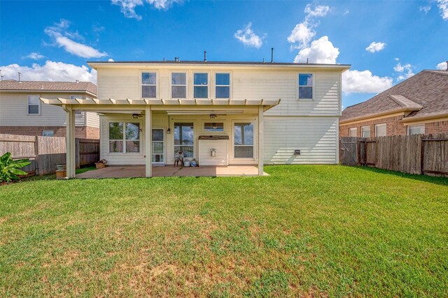 back of property featuring a pergola, ceiling fan, a patio area, and a lawn