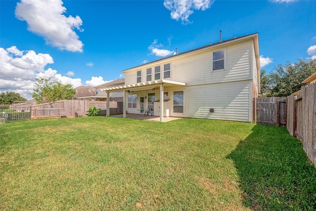 back of property with a lawn, ceiling fan, and a patio area