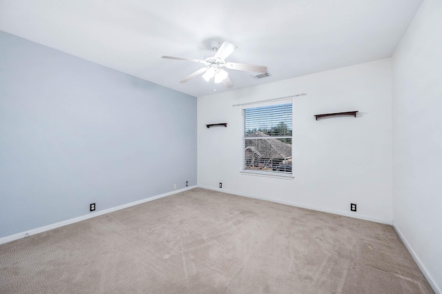 unfurnished room featuring light carpet and ceiling fan