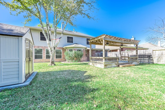 view of yard with a pergola, a wooden deck, and a shed