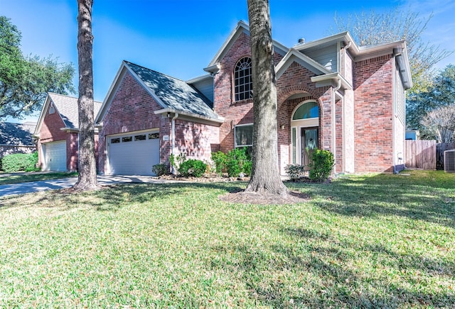 view of property featuring a front lawn, cooling unit, and a garage