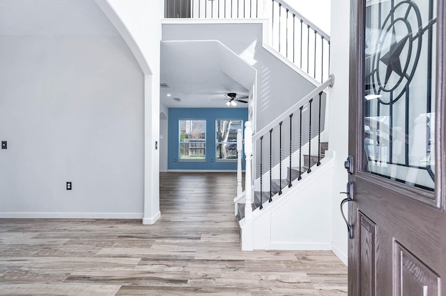 foyer entrance with ceiling fan and light hardwood / wood-style flooring