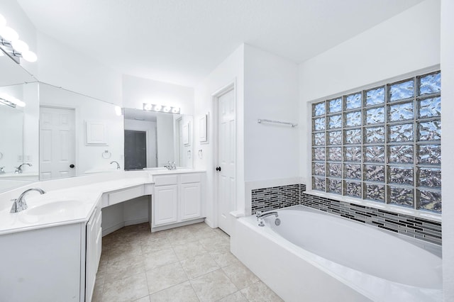 bathroom featuring a bathing tub, tile patterned flooring, and vanity